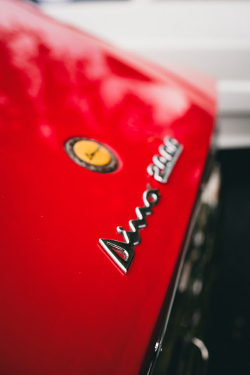 a close up of the emblem on a red car