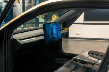 a picture of a mans face on a monitor in a car