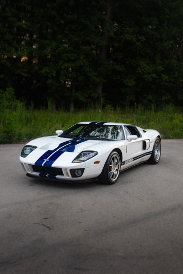 a white and blue sports car parked in a parking lot